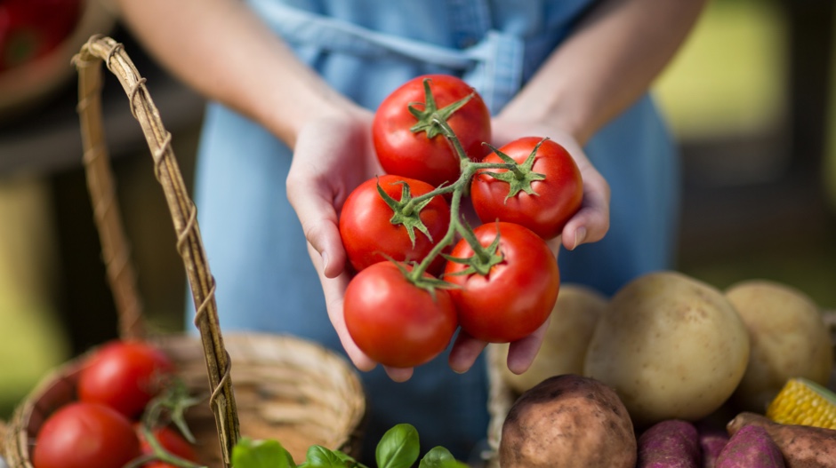 woman holding tomatoes