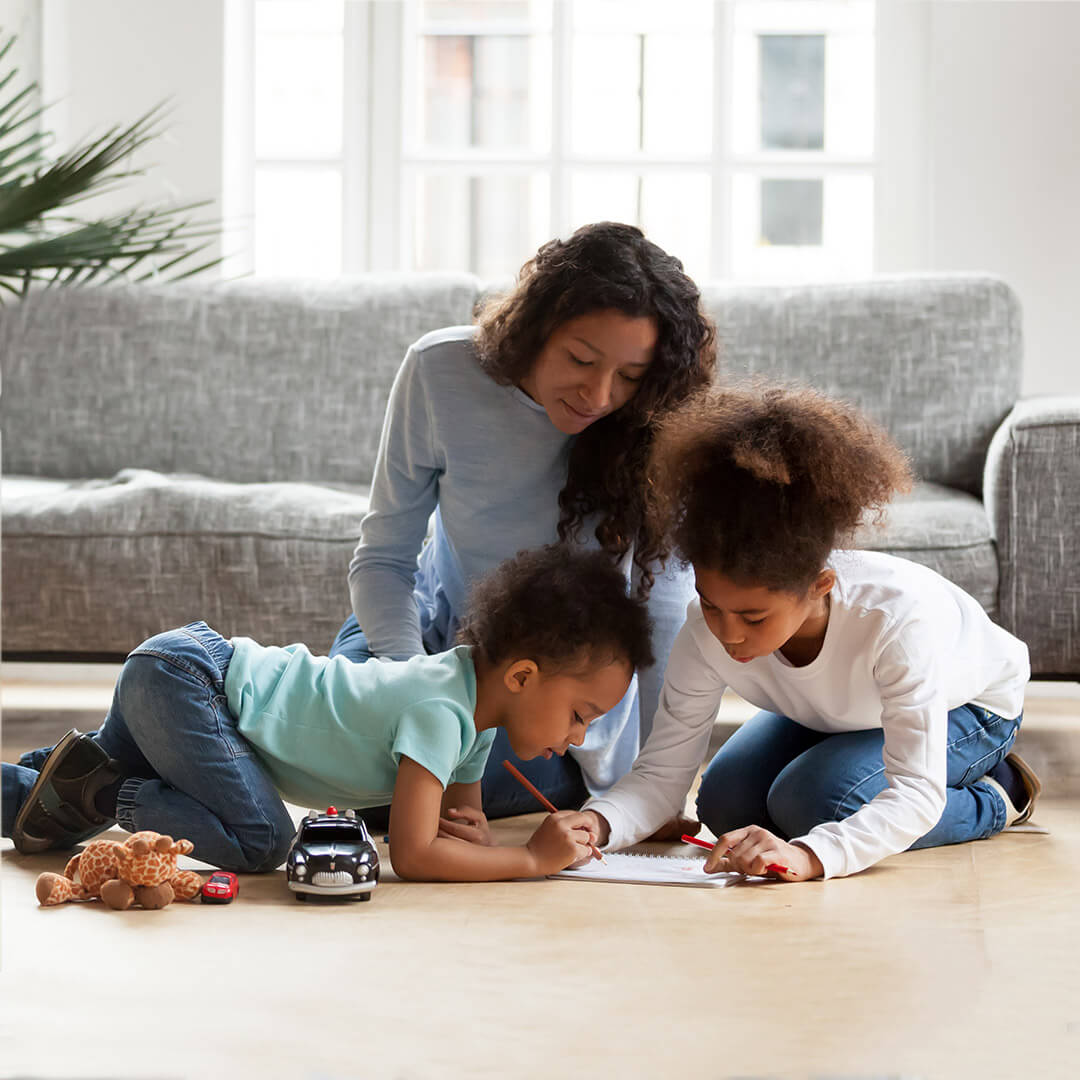 Woman sat playing with her two children