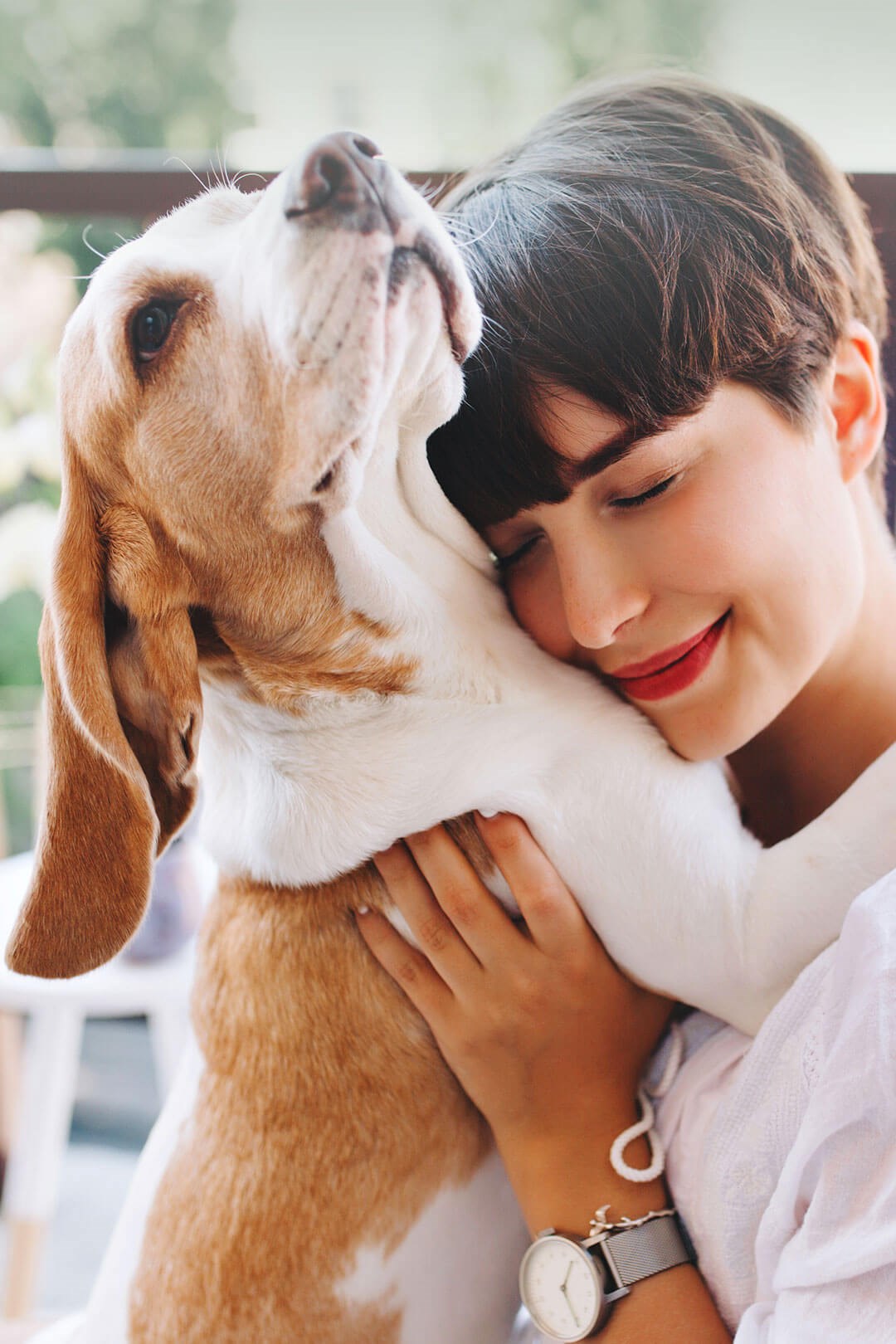 Portrait of woman hugging her dog