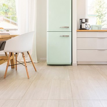 Clean kitchen floor with pale green fridge