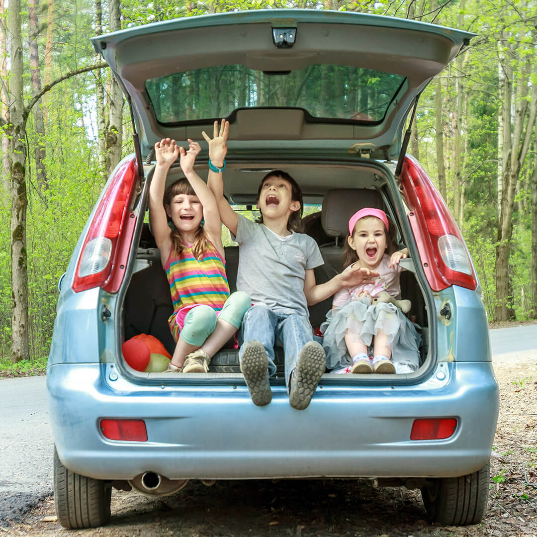 Kids sat in car boot