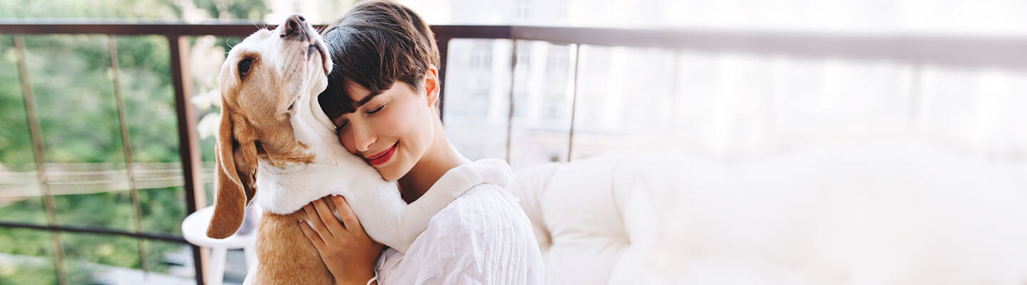 Wide angle of woman hugging her dog