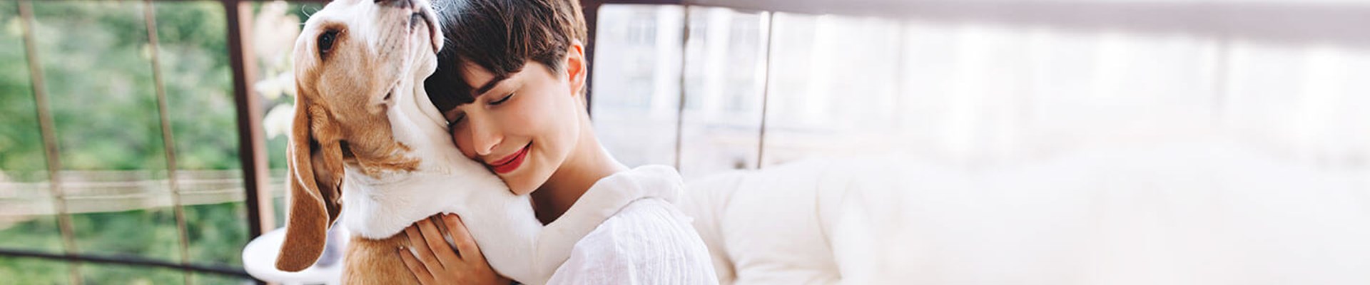 Wide angle of woman hugging her dog