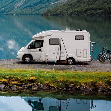 White mobile home by lake