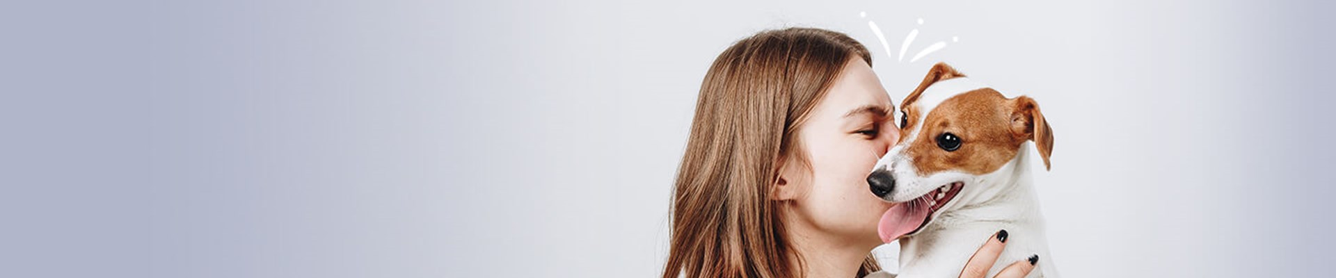 Woman kissing her dog wide angle